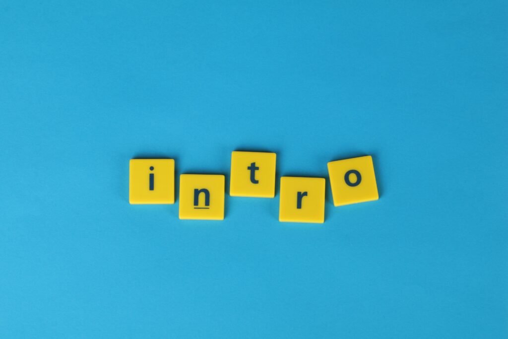 Yellow letter tiles spell 'intro' on a vibrant blue background, ideal for creative projects.